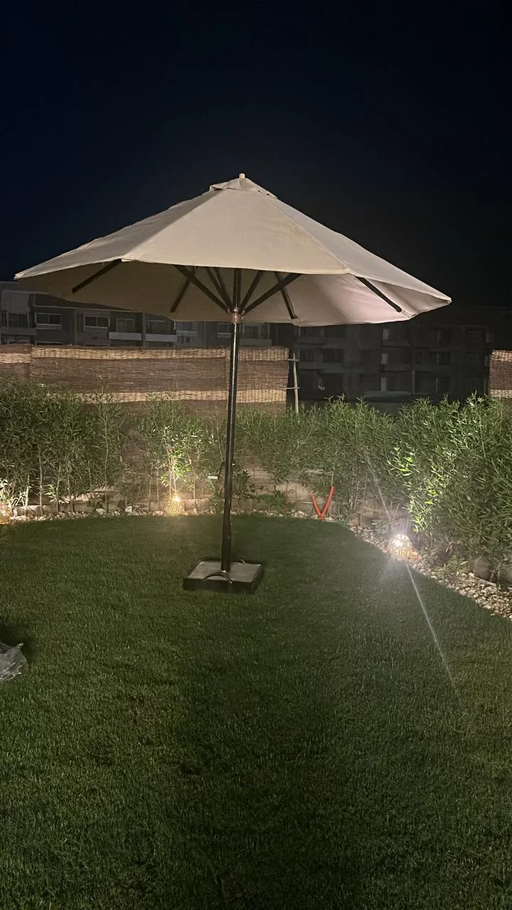 Nestica 4m mechanical center umbrella in a real garden setting